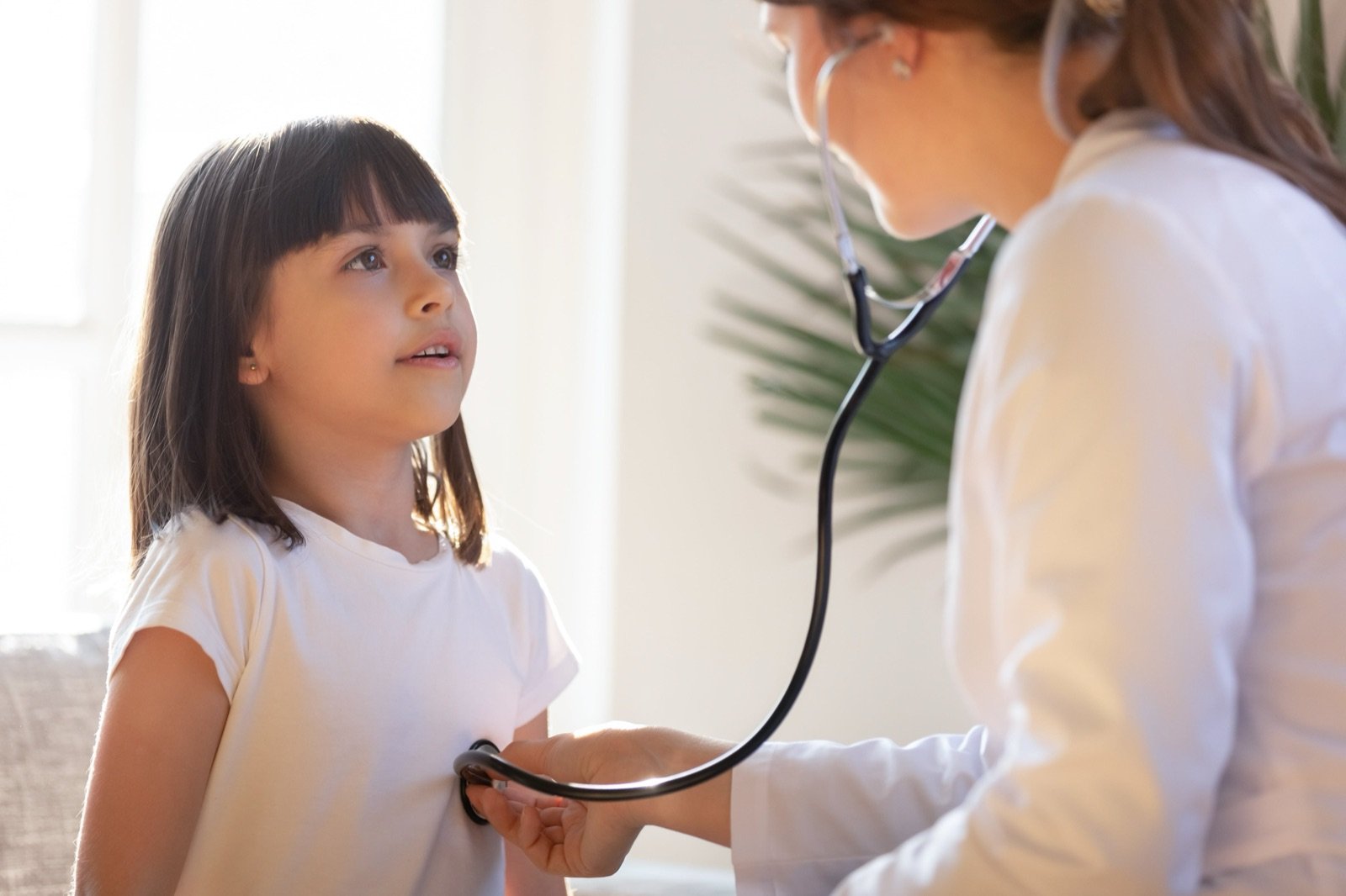A provider performing a physical exam at Atlanta Urgent Care